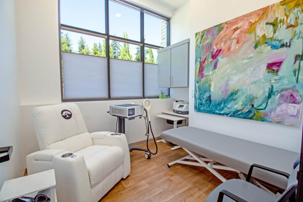 Maple Medical treatment room with recliner, exam table, and medical equipment